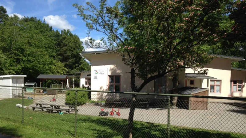 Bild på förskolan Arkens gård med trehjulingar utanför.