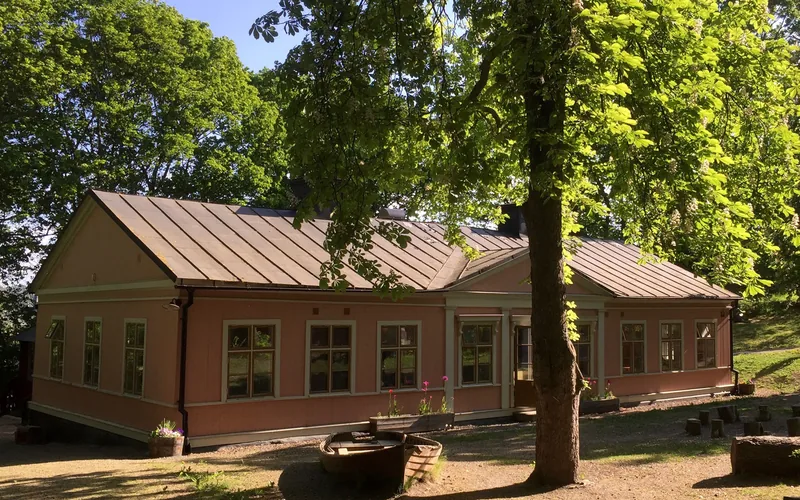 Låg förskolebyggnad sedd från gården.